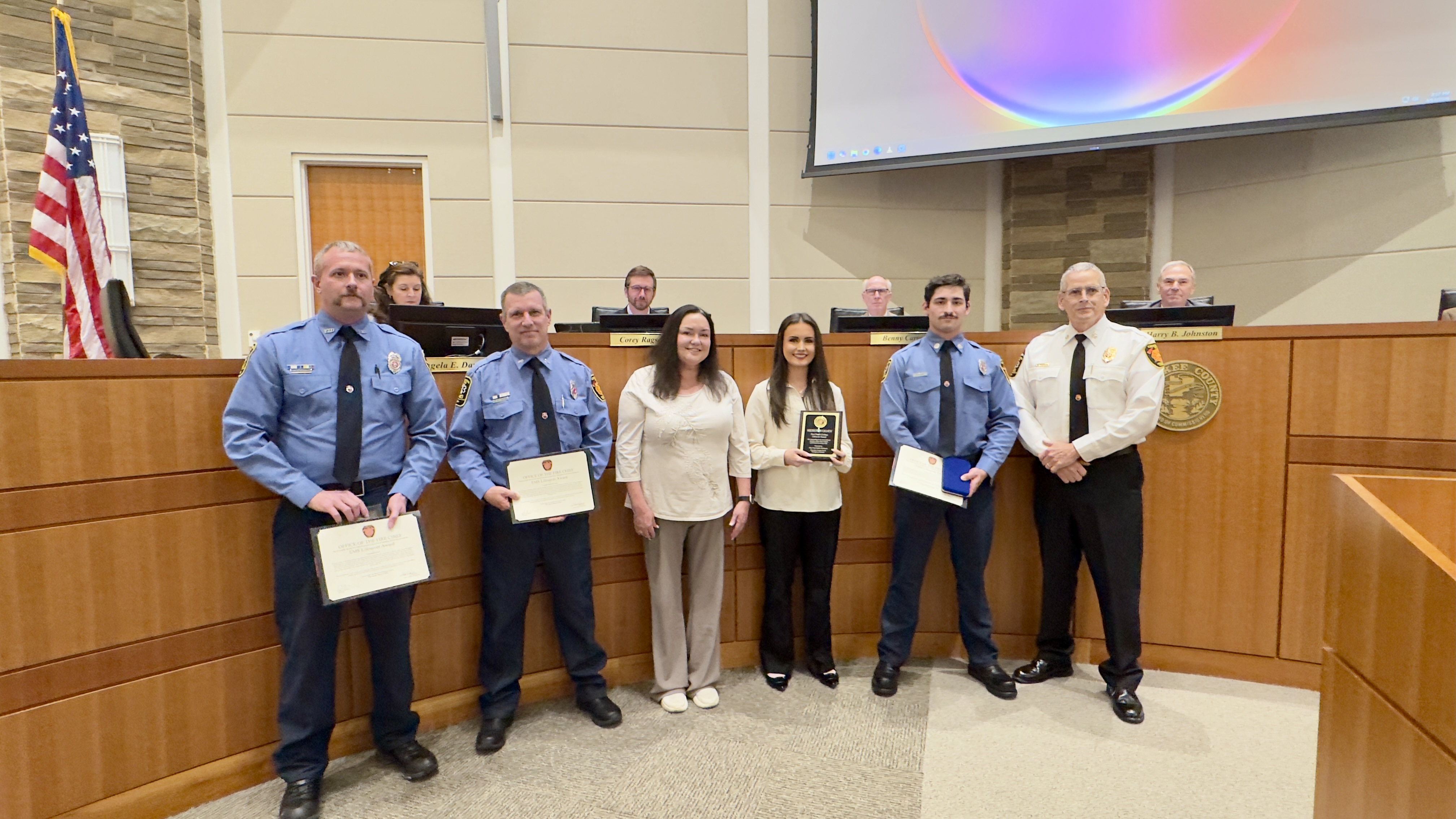 Firefighters receive the EMS Lifesaver and Fire Chief's Civilian LIfesaver Awards for their work at a recent incident. 